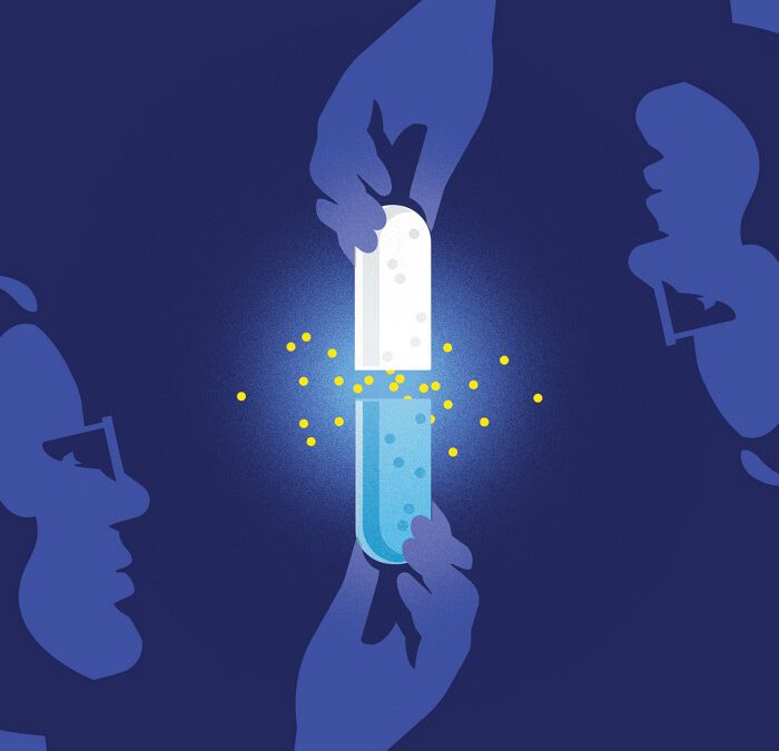 A mostly blue-hued illustration of someone in glasses holding an open capsule. A hand from above pulls on the other end of the capsule, which is white. Where the capsule is opened, yellow dots glow.