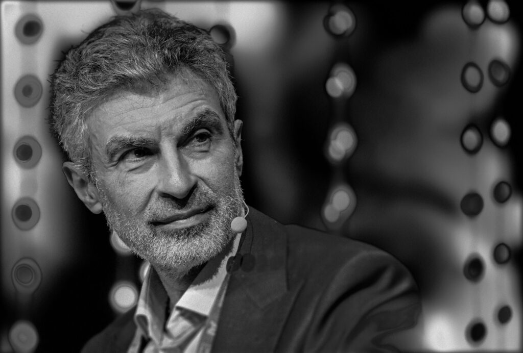 Yoshua Bengio pictured at a conference in black and white