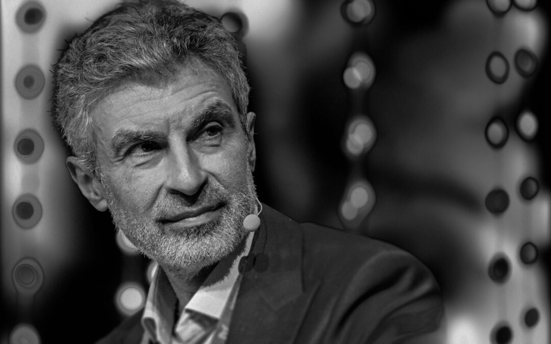 Yoshua Bengio pictured at a conference in black and white