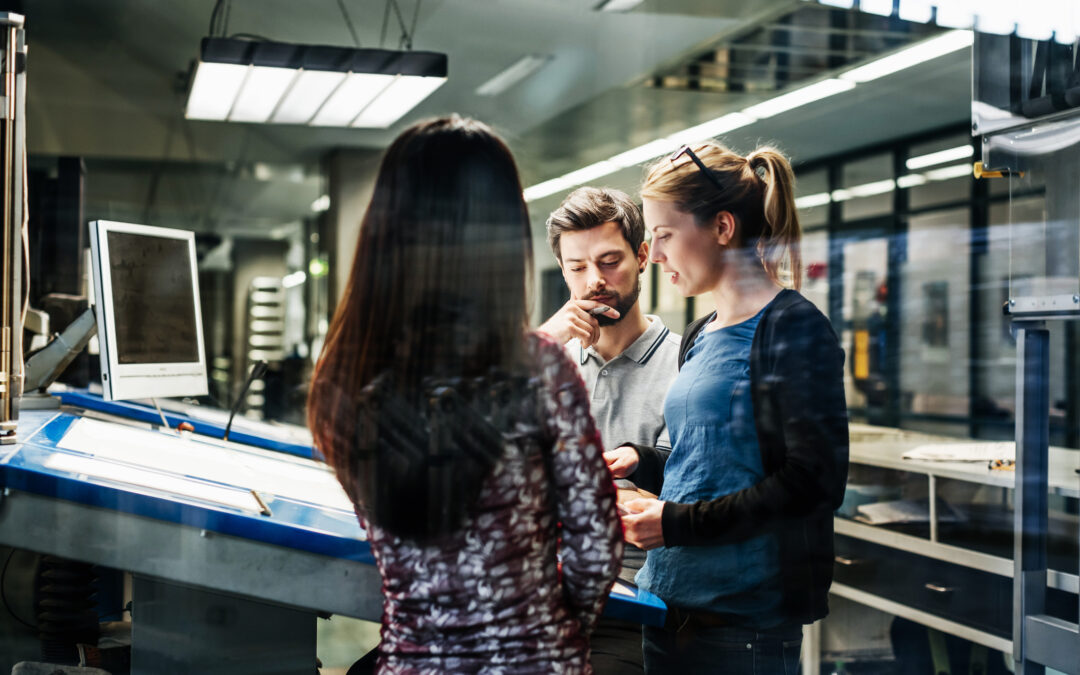 Printing Plant Engineers Working Together At Console