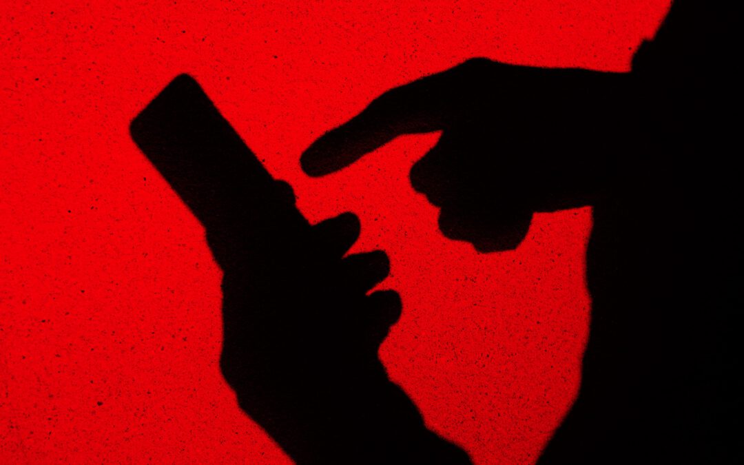 Shadow of a person operating a smartphone